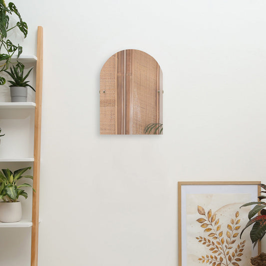 Arch teal tilt beveled edge mirror mounted on white wall and greenery flowers for decoration