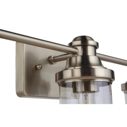 Close-up view of the Allen + Roth Ivy 3-Light Vanity Light, highlighting the champagne finish and clear glass shade design.