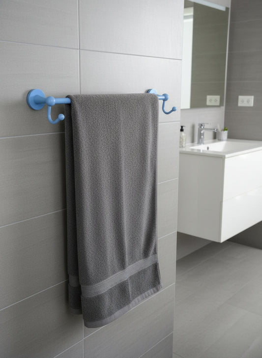 24" flat troll blue towel bar with integrated hooks staged with a grey towel in a white bathroom