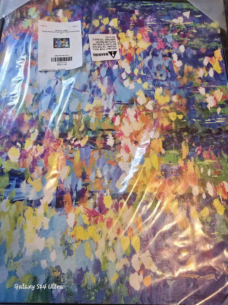 Colorful abstract painting with a clear plastic cover and visible brand label.