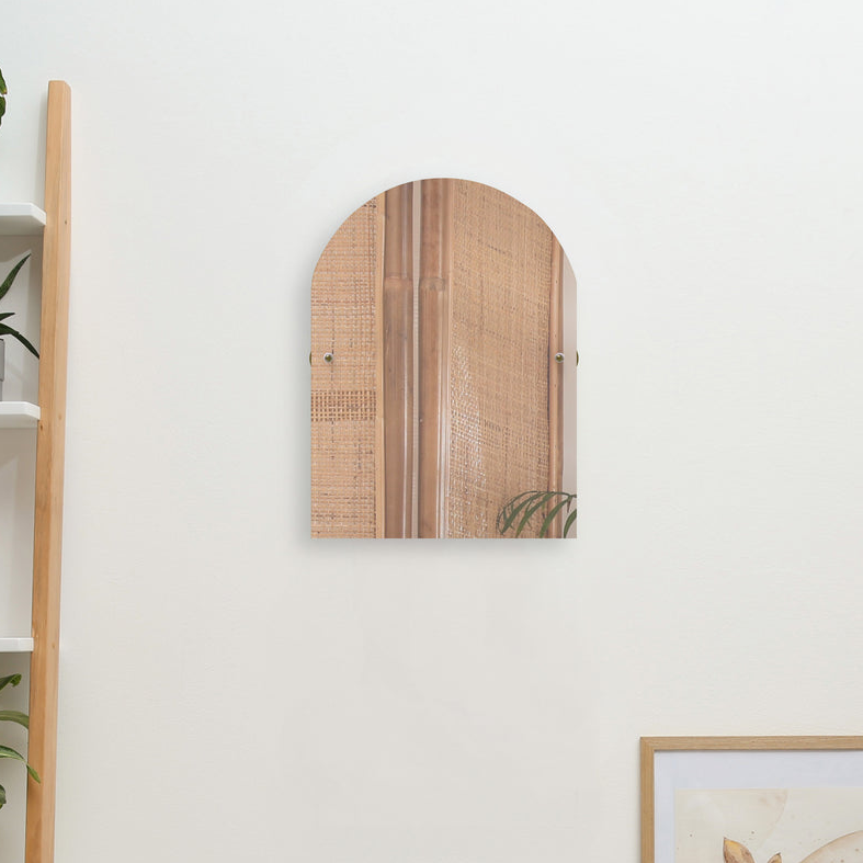 Arch teal tilt beveled edge mirror mounted on white wall and greenery flowers for decoration