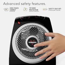 Vornado personal heater with safety features and a hand touching it