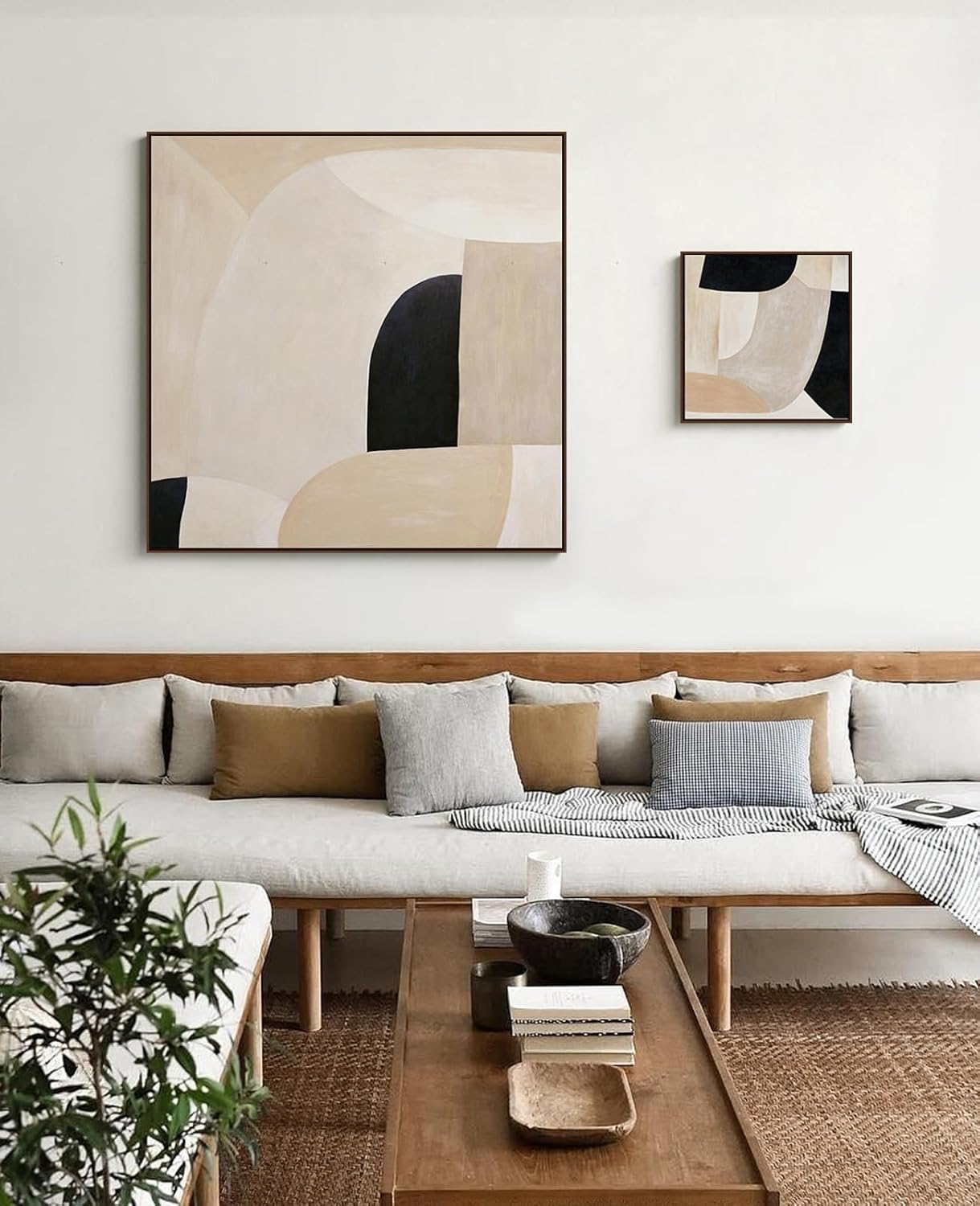 Modern walnut canvas frame for square art, mounted above neutral couch setup