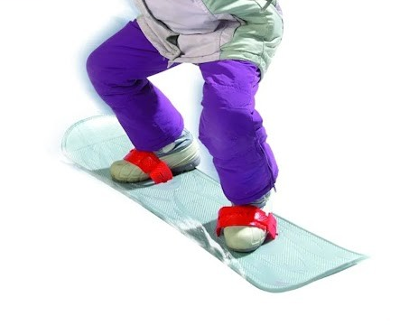 Person wearing purple pants standing on a small snowboard against a white background