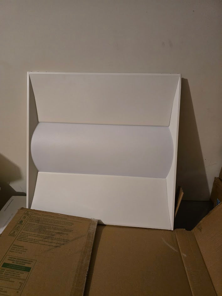 Troffer light against white wall under cardboard