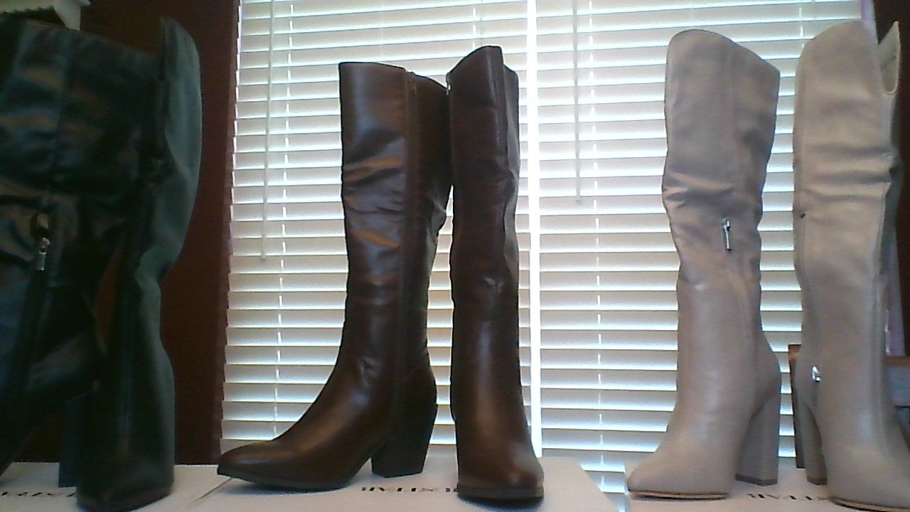 Front view of three pairs of women’s knee-high boots in size 6, featuring black, chocolate brown, and tan faux leather with side zippers and mid heels
