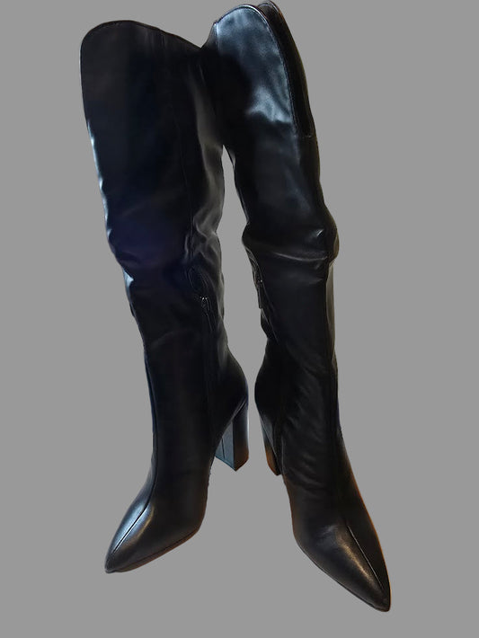 Black knee-high boots with a white background