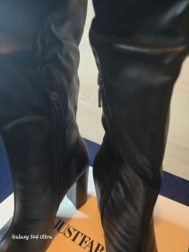 showing the zipper on the black boots