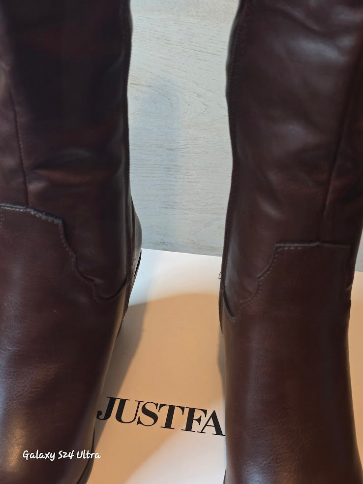 Brown leather boots on a JustFab brand box showing front details