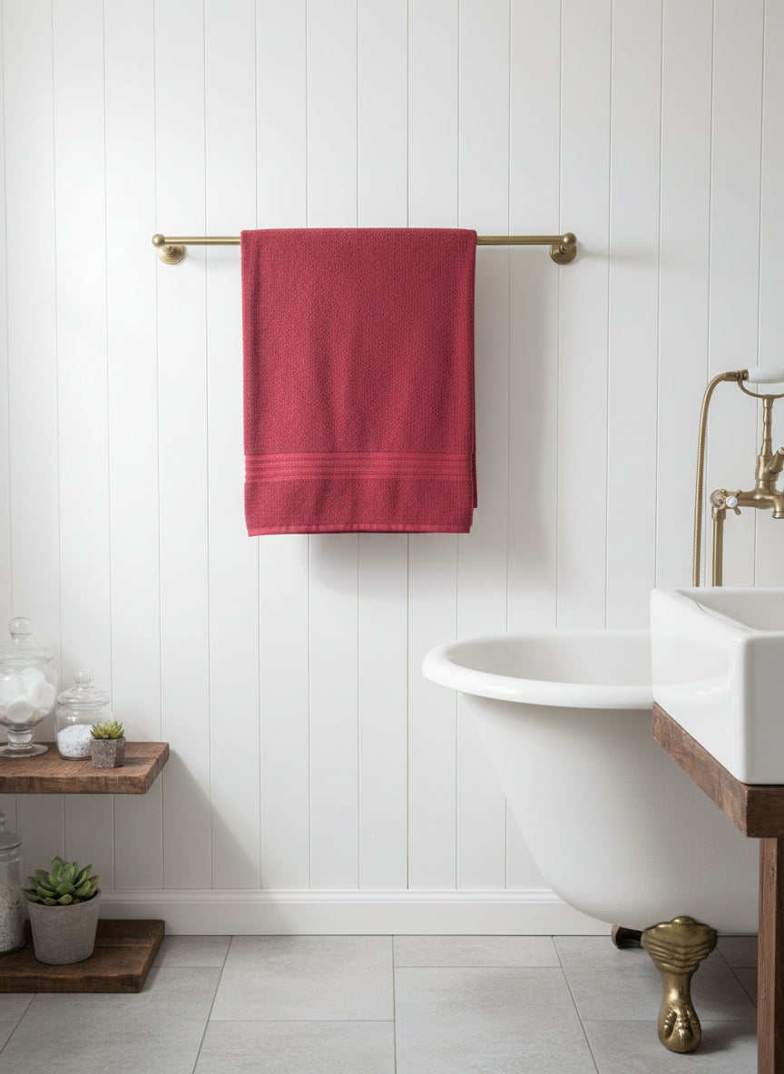 30" brushed bronze towel bar staged with burgundy towel in bathroom with white walls