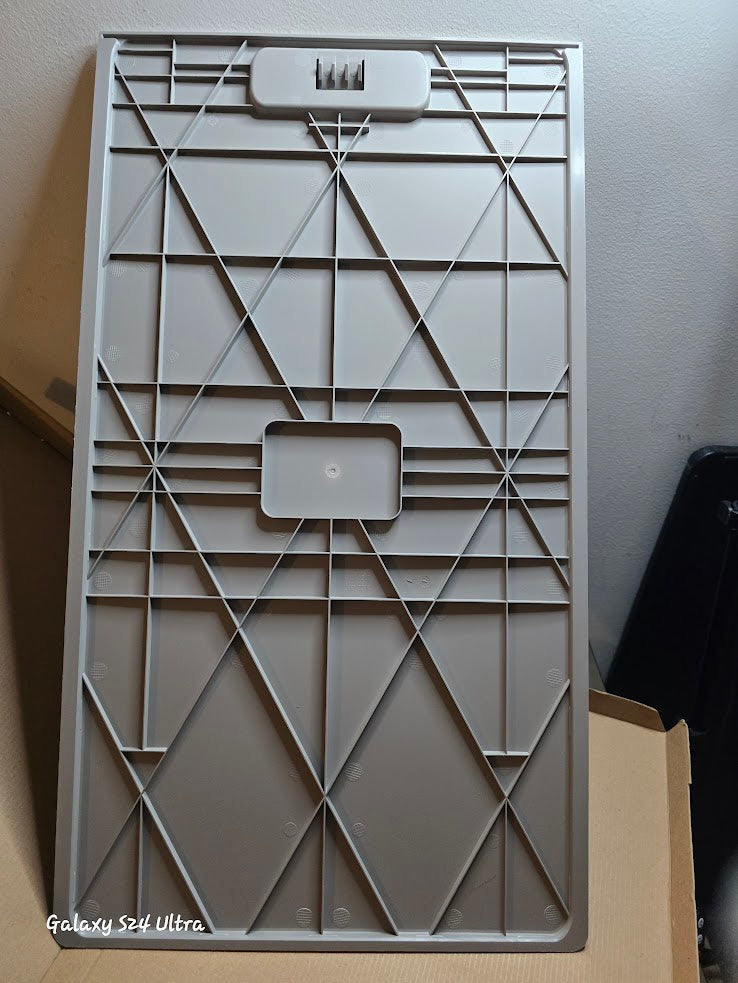 Geometric patterned gray plastic cover on a plain background