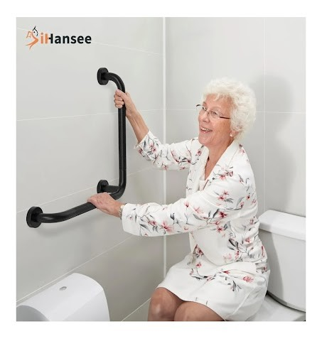Woman using a black grab bar in a bathroom near the toilet, with 'iHANSEE' branding