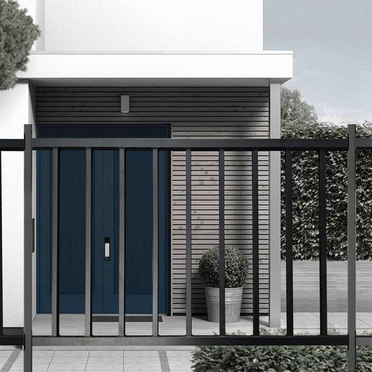 Modern house exterior with a black metal gate and blue door.
