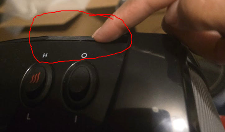 Hand pointing at small crack circled in red